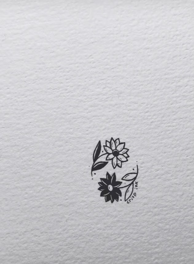 a black and white drawing of flowers on the side of a piece of paper with ink