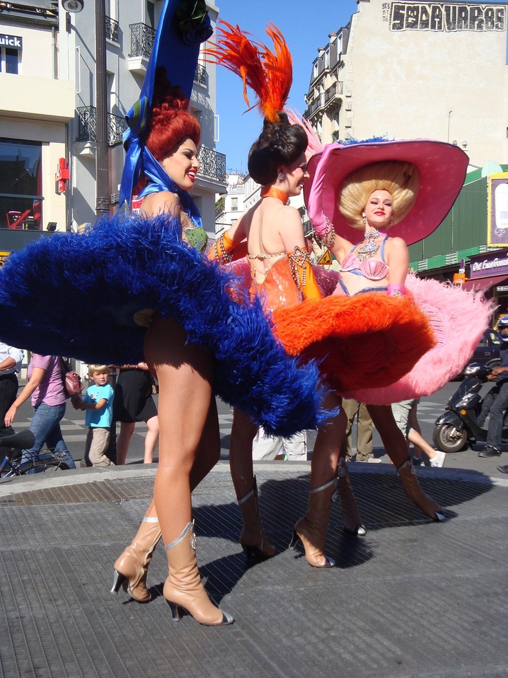 two women in costumes are walking down the street