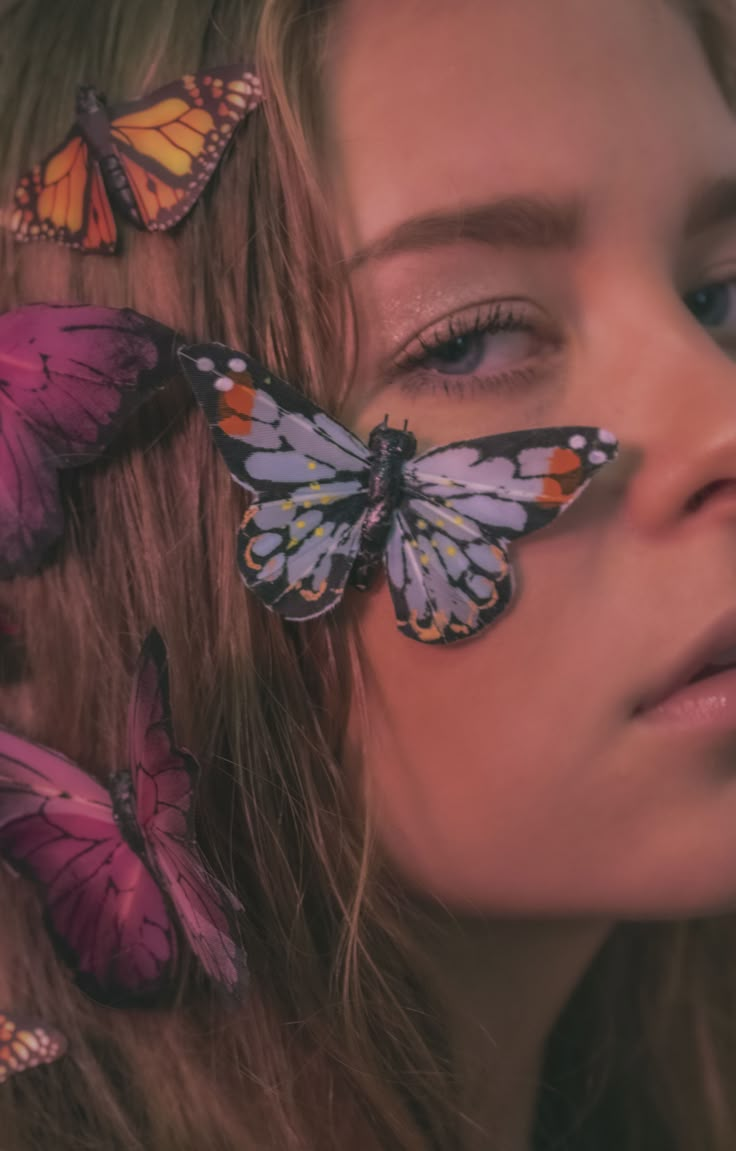 a woman with butterflies on her face