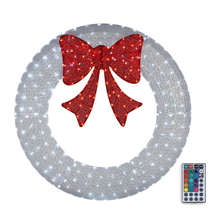 a lighted wreath with a red bow on it