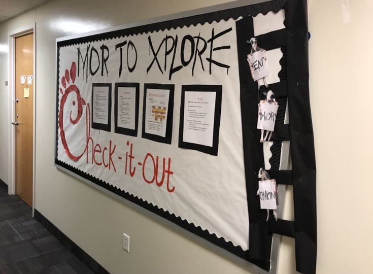 a bulletin board with writing on it in an office hallway