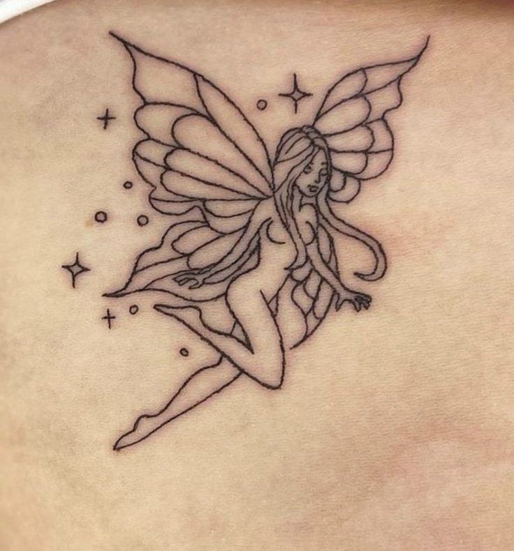 a woman's back with a small tattoo on her shoulder and the image of a fairy