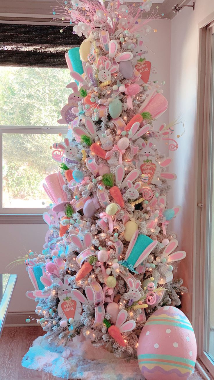 a white christmas tree with pink and blue decorations