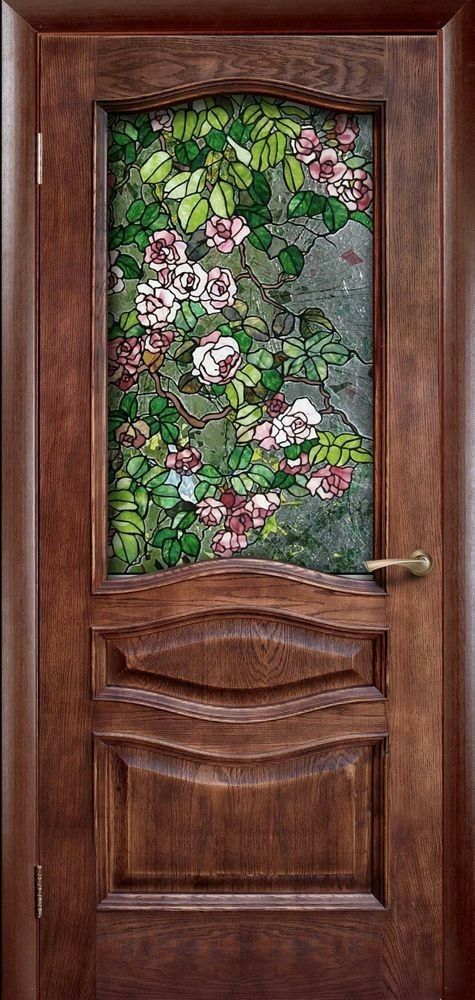 a wooden door with stained glass and flowers on it