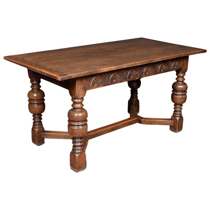 an old wooden table with turned legs and carvings on the top, isolated against a white background