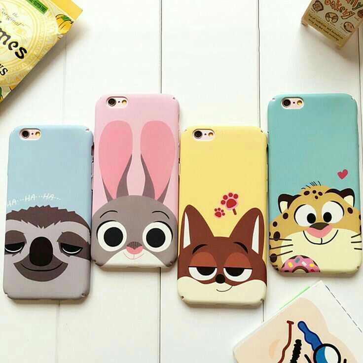 four phone cases with cartoon animals on them sitting next to each other, one has a cat and the other has a raccoon