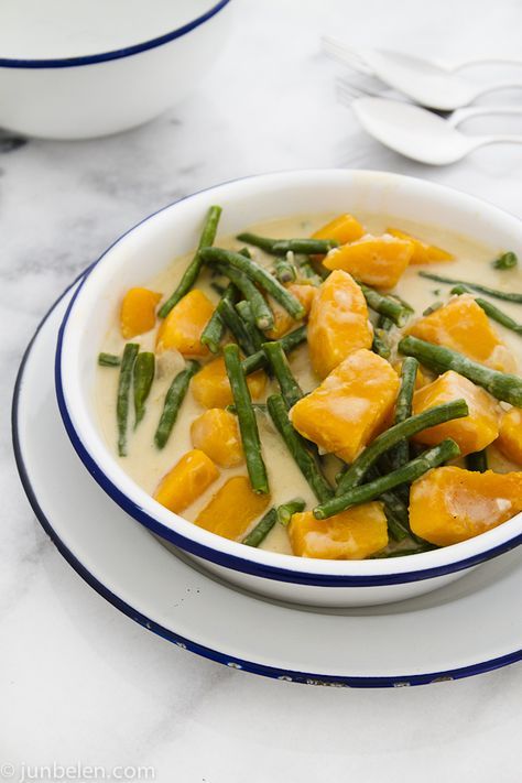 a white bowl filled with green beans and potatoes