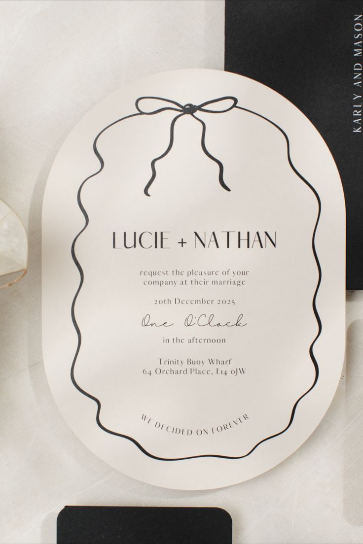 A modern wedding invitation is displayed, featuring a double arch design with a hand-drawn squiggly border and a bow. The invitation has an almond tone and is adorned with a bow, exuding a modern and stylish aesthetic. It's described as on-trend and designed by papergrace.co.uk Scribble Wedding Invitation, Wedding Menu With Bow, Bow Wedding Invitations, Simple Wedding Invite, Modern Stationary Design, Wedding Invite Ideas, Wedding Stationary Design, Modern Invitation Design, Bow Invitation