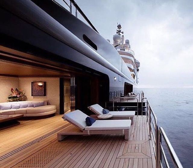 two chaise lounges on the deck of a large boat in the open water