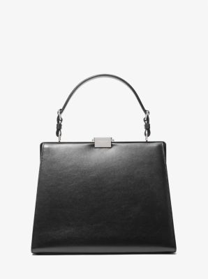 The epitome of polished glamour. The Simone satchel is crafted in Italy from rich calf leather in a structured top-handle silhouette with understated hardware. Carry it against both day and evening ensembles for a ladylike finish. Structured Top, Leather Satchel, Interior Details, Top Handle, Calf Leather, Zip Pockets, Satchel, Silver Tone, In Italy