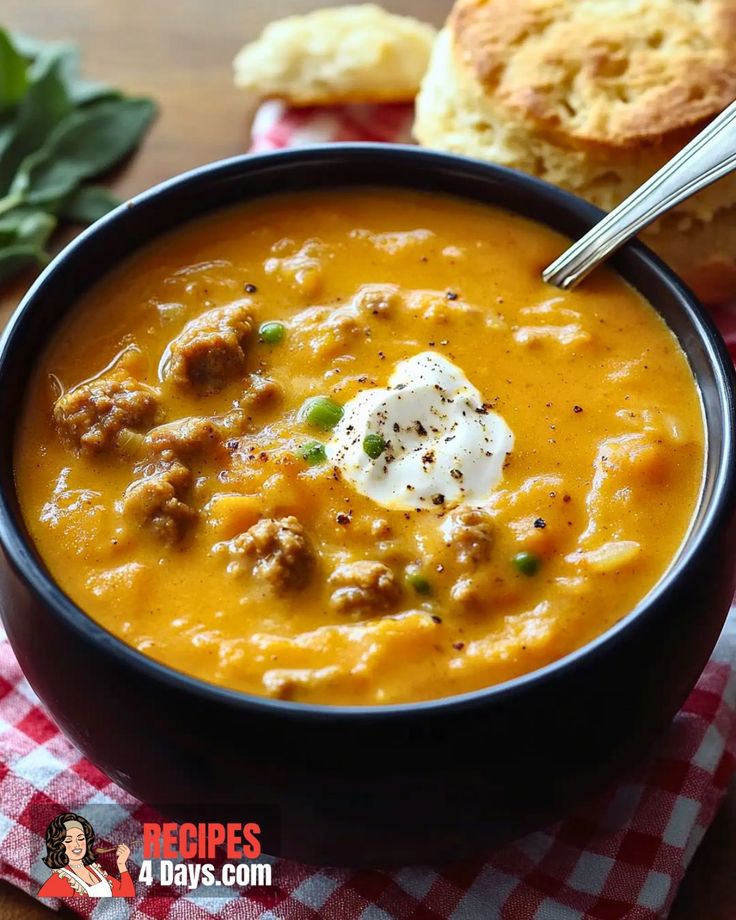 a bowl of soup with meatballs and sour cream