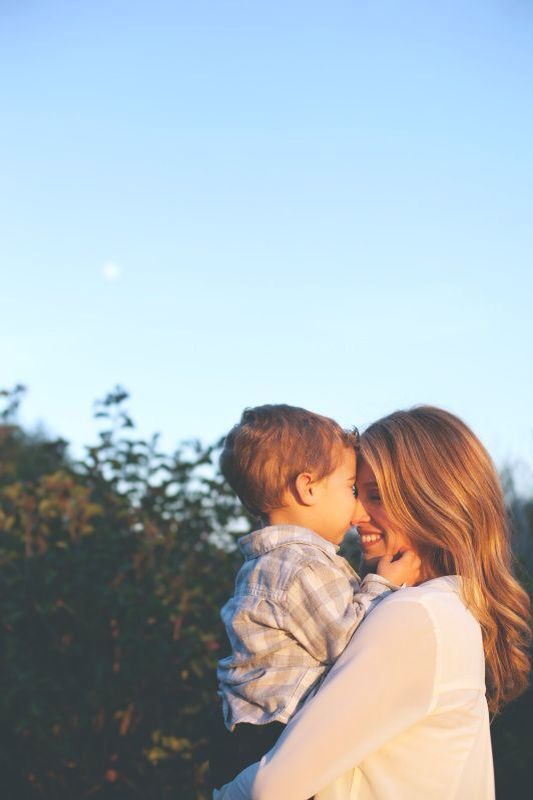 a woman holding a small child in her arms