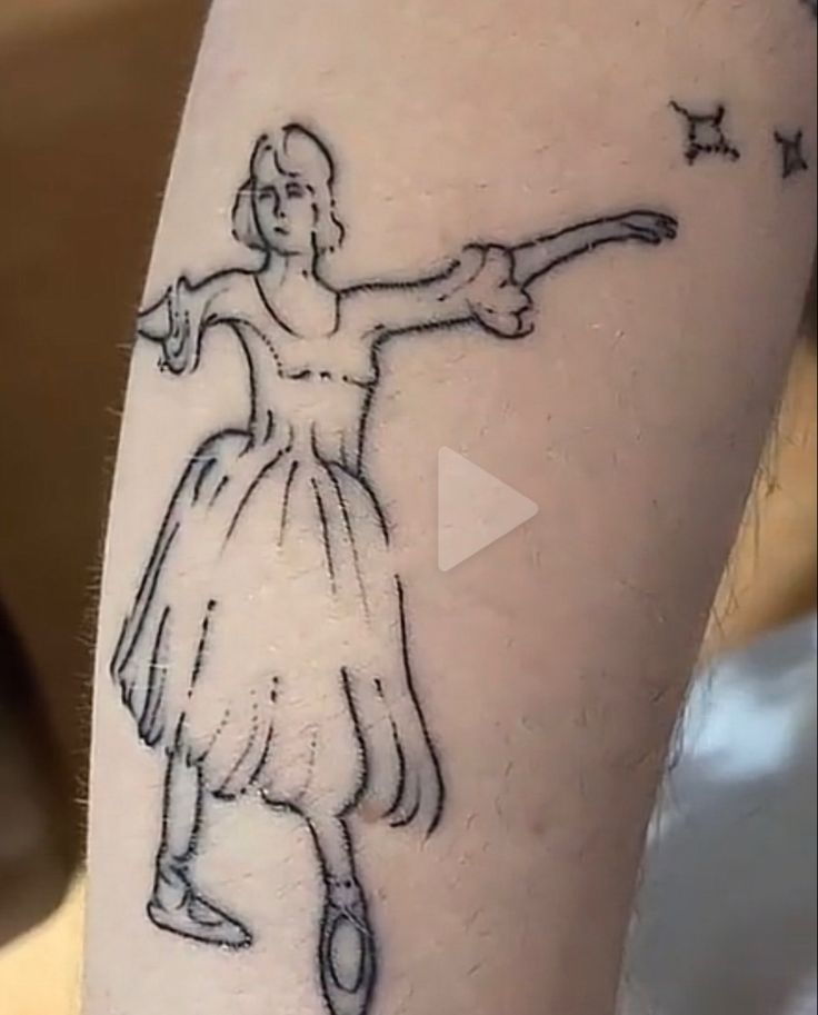 a woman's arm with a drawing of a ballerina holding a wand on it