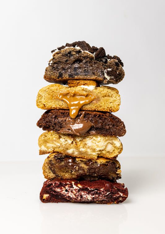 a stack of cookies and doughnuts sitting on top of each other in front of a white background