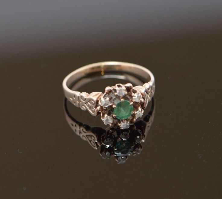 an antique diamond and emerald engagement ring