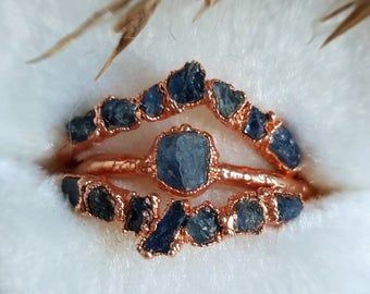 a close up view of some kind of ring with blue stones on it's side