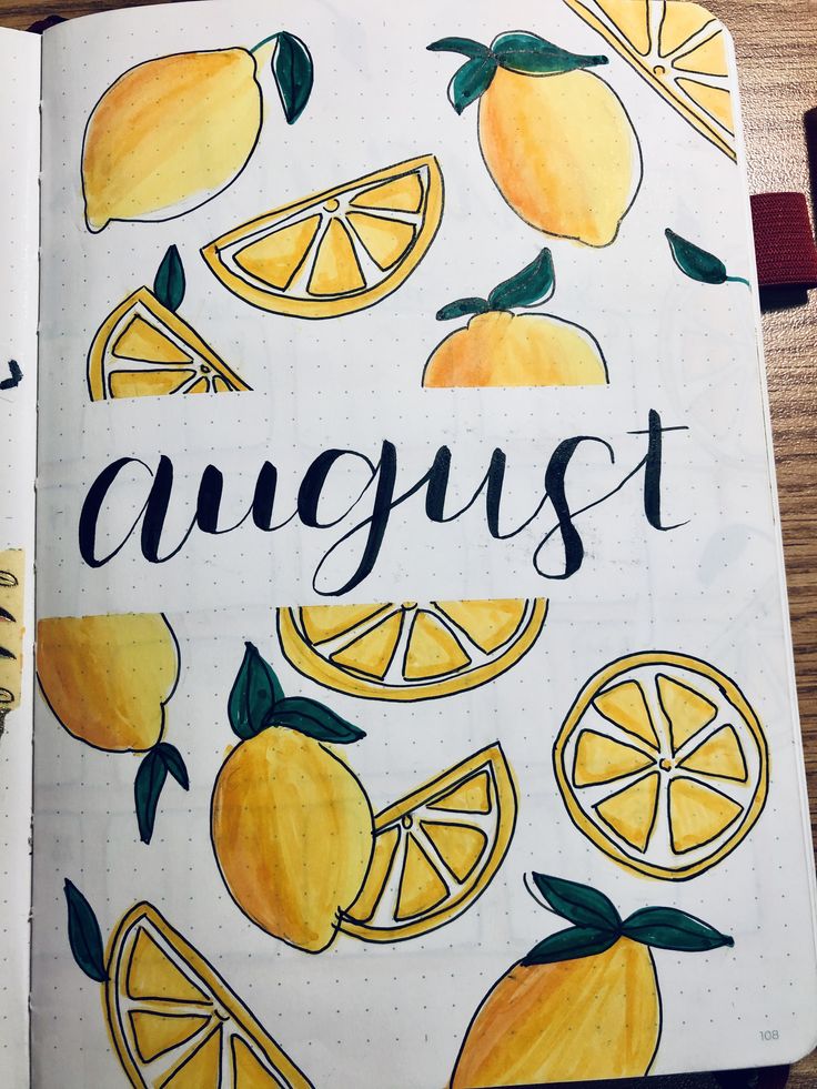 an open notebook with yellow lemons and the word august written in cursive writing