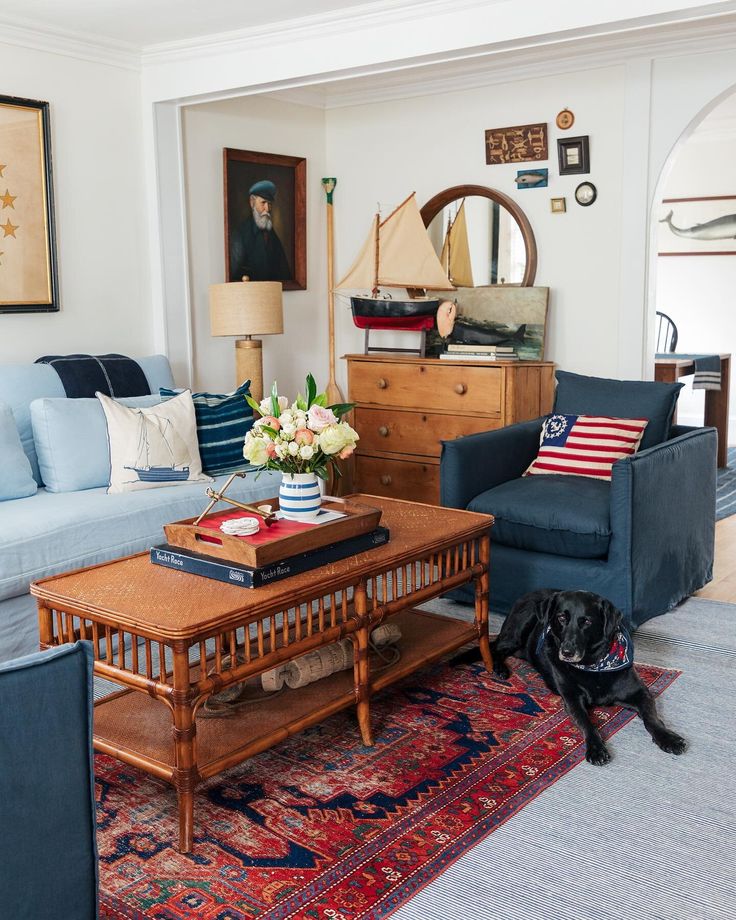 a living room filled with furniture and a dog laying on top of a rug in front of a coffee table