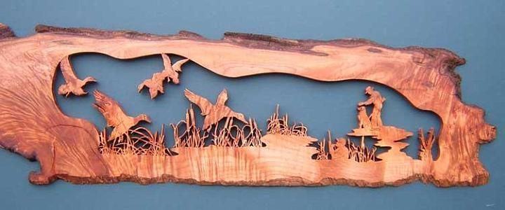 a piece of wood that has been carved to look like a landscape