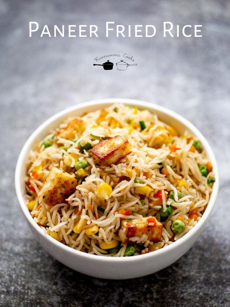 a white bowl filled with rice and vegetables on top of a gray countertop next to the words paneer fried rice