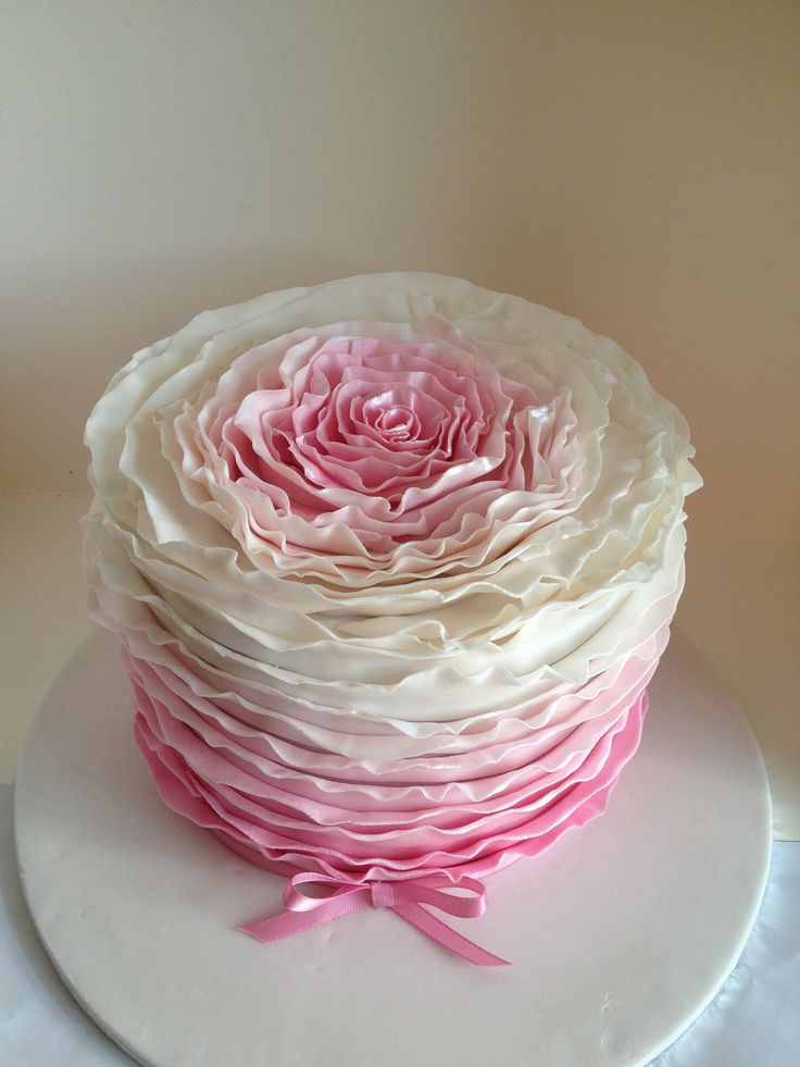 a white cake with pink and white frosting