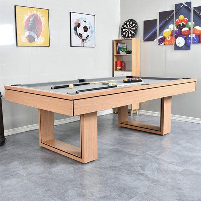 a pool table in a room with several pictures on the wall and two foo - pong tables