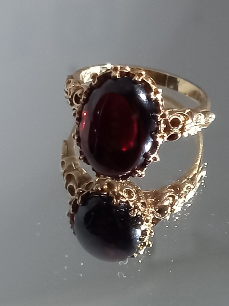 Absolutely stunning genuine natural Garnet ring. Please find for sale an extremely fine 9ct gold large heavy Victorian style cabochon garnet ring. The ring weighs 5.4grams. It has makers mark NK. It is fully hallmarked. Set with a beautiful large cabochon Garnet, of stunning colour approx 5ct. Also exceptional gold work. The face of the ring measures 13 x 9mm. The ring weighs 5.4grams heavy . It is ring size O 1/2 / USA size 7 1/2 and is offered in good condition Such a beautiful eye catching an Large Garnet Ring, Blood Ring, Victorian Rings Vintage, Antique Garnet Ring, Vintage Ruby Ring, Antique Gold Ring, Dark Rings, Rings Vintage, Beautiful Eye