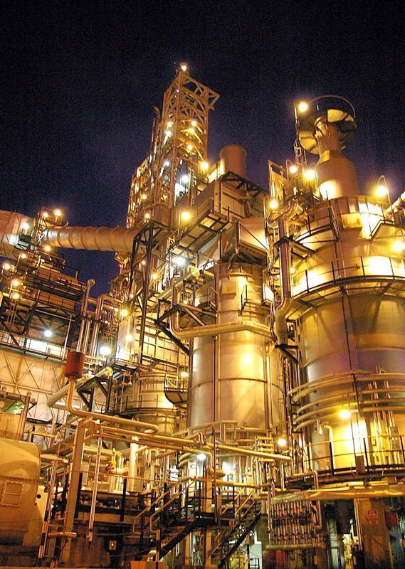 an oil refinery at night with lights on