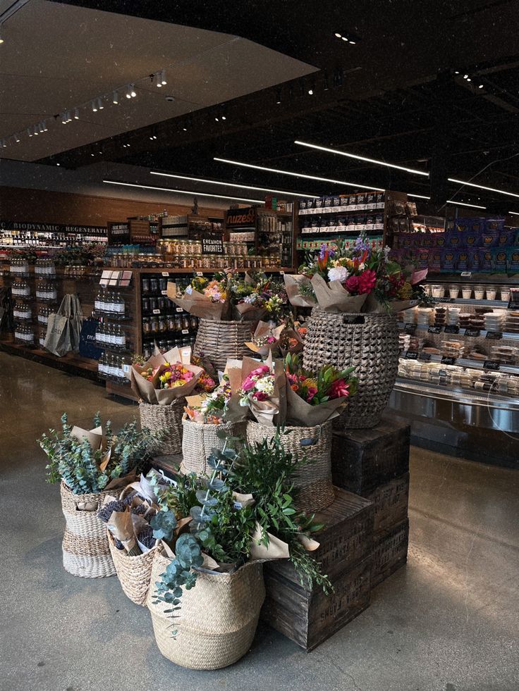 baskets filled with flowers sitting on top of each other in front of a store shelf