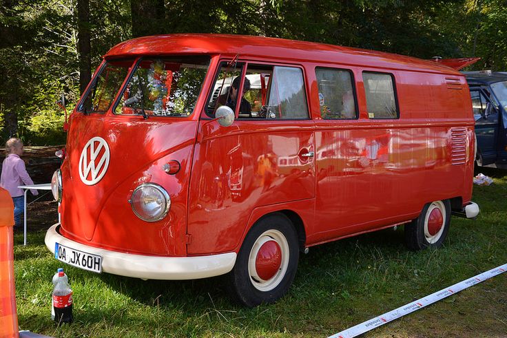 an old vw bus is parked in the grass