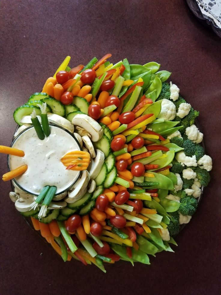 a platter filled with veggies and dip