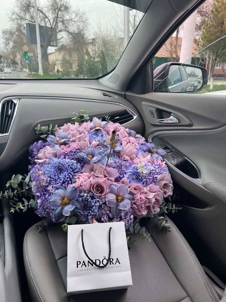 a bouquet of flowers in the back seat of a car