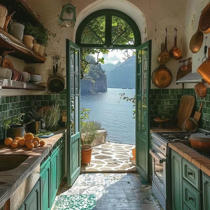 an open door leading to a kitchen with green cabinets and pots on the counter top