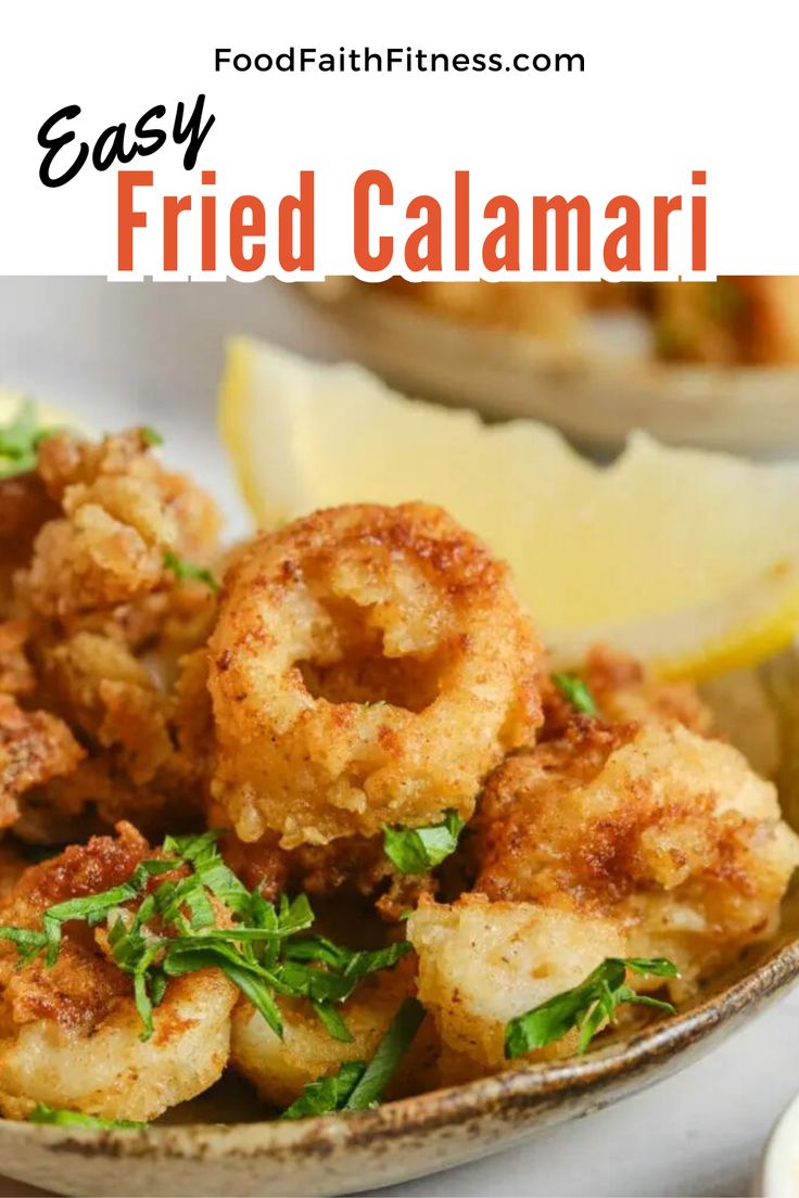 fried calamari in a bowl with lemon wedges