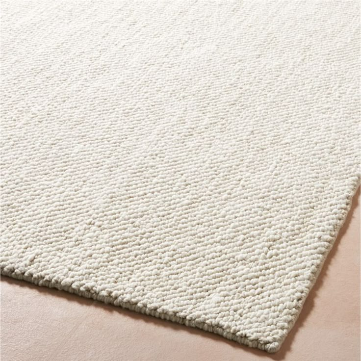 a white rug on top of a wooden floor