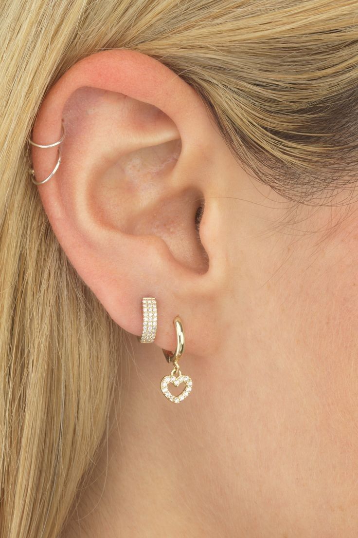 a close up of a woman's ear with two small hoops on it