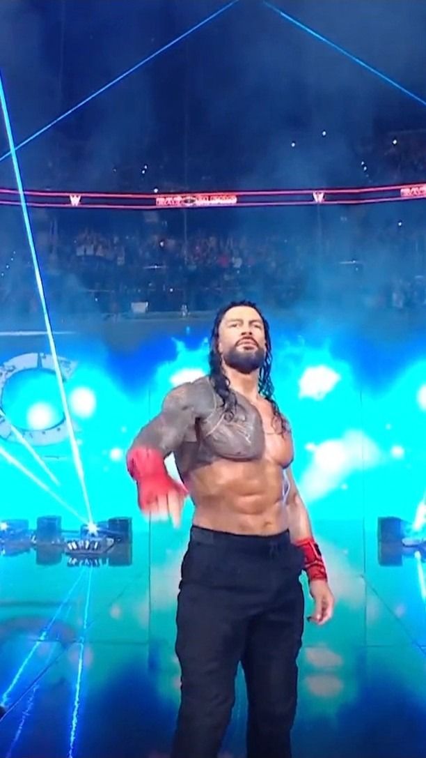 a man standing on top of a wrestling ring