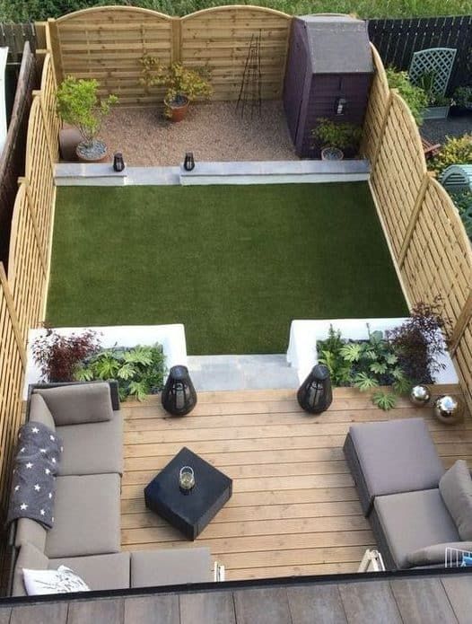 an aerial view of a small backyard with furniture and landscaping in the back ground area