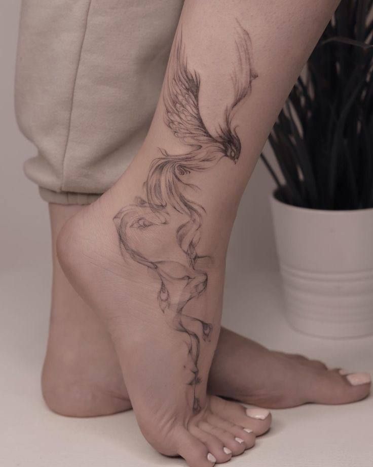 a woman's foot with a bird tattoo on her left leg and the bottom part of her legs