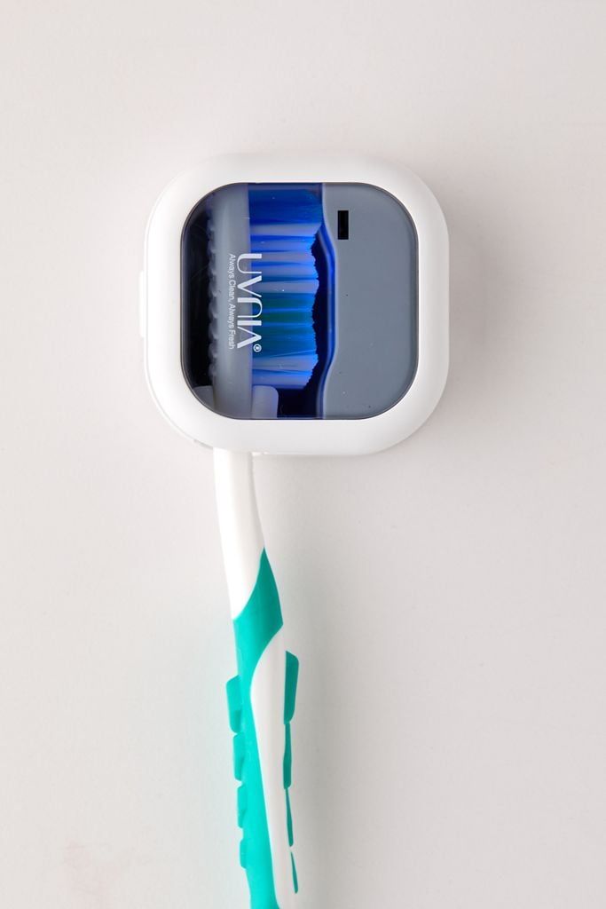 an electric toothbrush sitting on top of a white wall