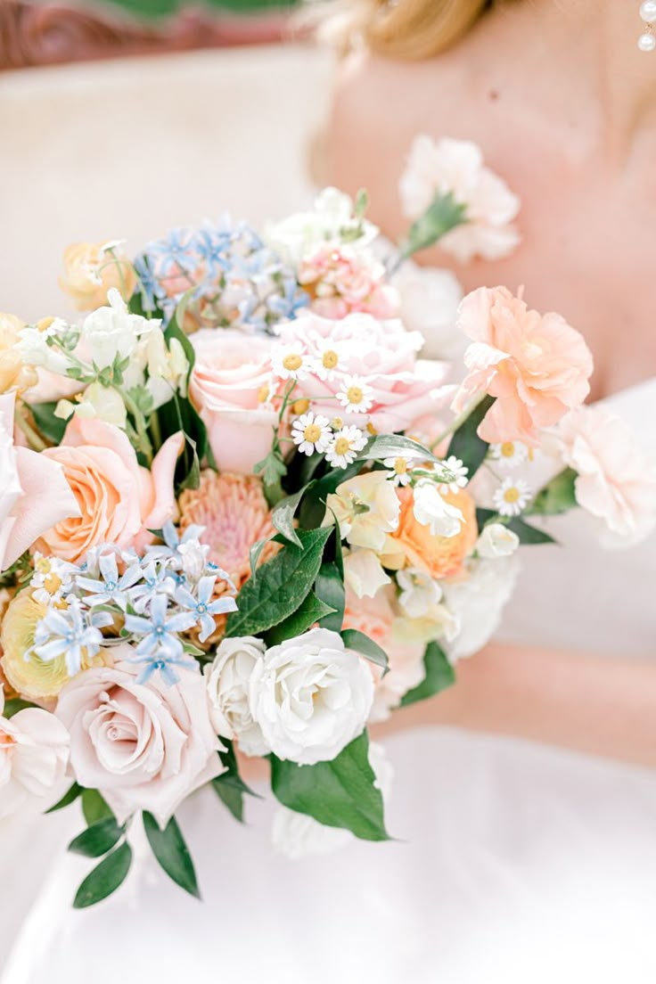 a bride holding a bouquet of flowers in her hand