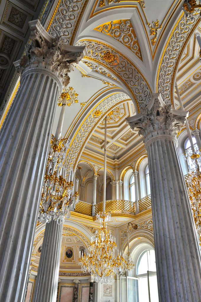 an ornate building with columns and chandeliers