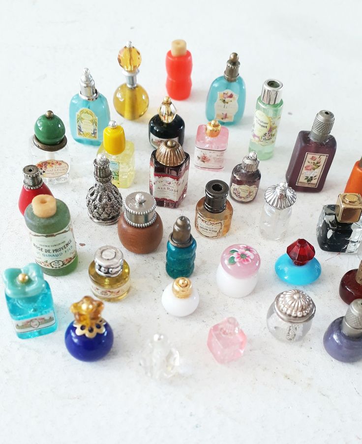 an assortment of perfume bottles on a white surface