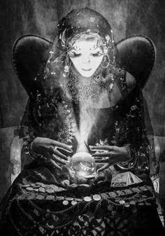 a black and white photo of a woman holding a crystal ball