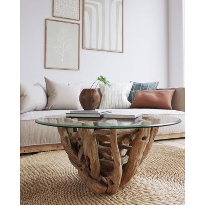 a glass table sitting on top of a rug next to a couch