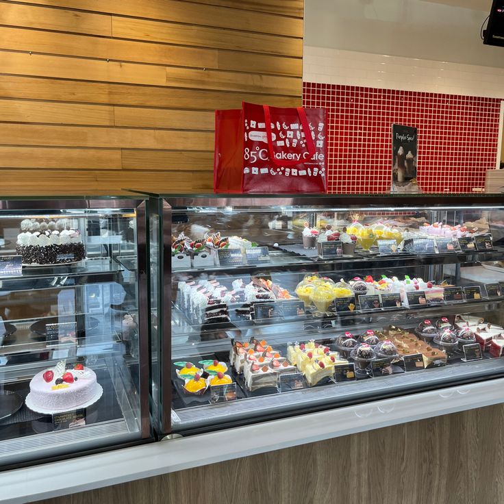 a display case filled with lots of different types of cakes