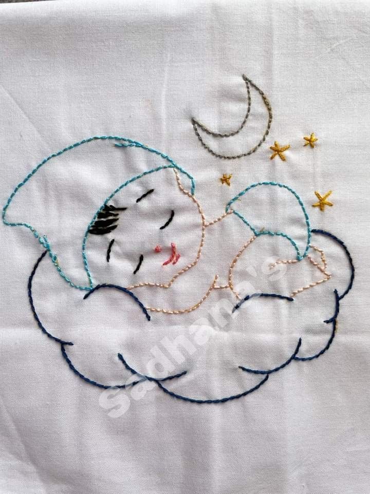 an embroidered baby sleeping on top of a cloud with stars and moon in the sky