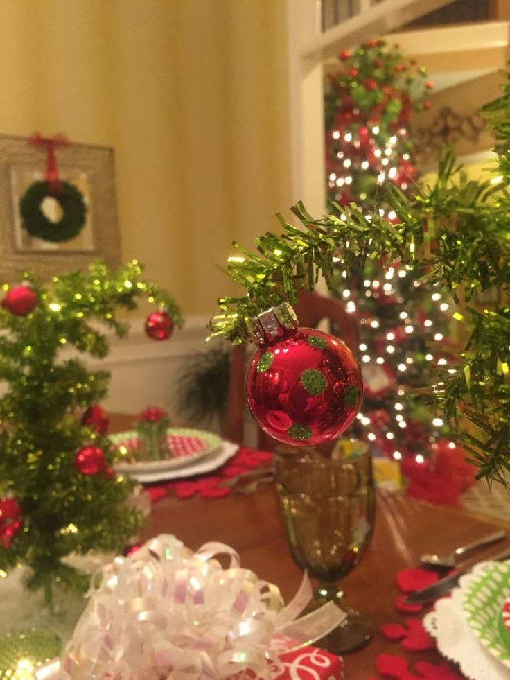 a table set for christmas with ornaments on it