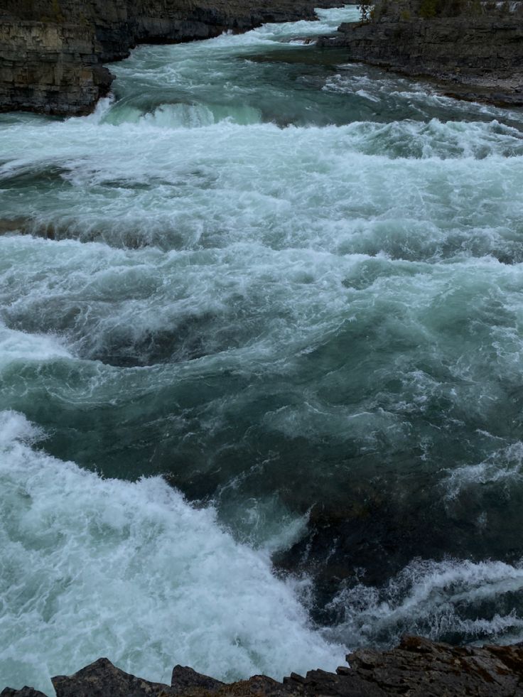 the water is rushing down the rocks in the river