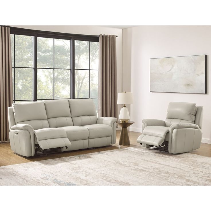 a living room with two recliners and a chair